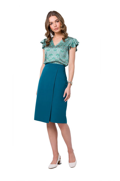 Model displaying the Stylove Classic A-Line Skirt in teal from the front, paired with a fashionable top and elegant white heels.