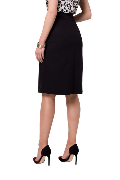 Stylove elegant A-line skirt showcasing an asymmetrical design, worn with stylish heels, viewed from the back to highlight its sophisticated silhouette.