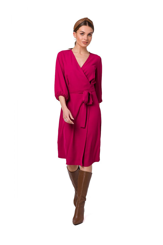 Stylove Flared Overlap Dress in vibrant pink, featuring wide sleeves and elegant waist binding, modelled by a woman wearing knee-high brown boots, showcasing a luxurious feminine style.