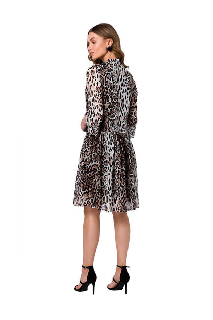 Model showcasing the back of the Stylove Ethereal Chiffon Daydress in a striking leopard pattern, highlighting the stylish tie neckline and versatile elbow-length sleeves, a perfect blend of comfort and fashion.