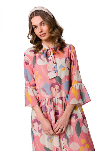 Close-up of a fashionable woman wearing the Stylove Ethereal Chiffon Daydress in a vibrant floral design, with a delicate tie at the neckline, exuding elegance and charm.