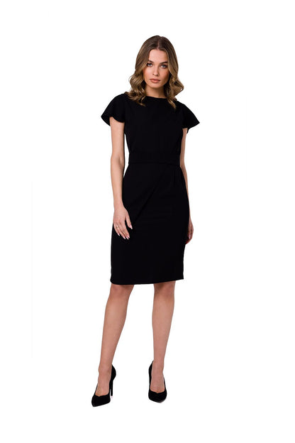 Stylove elegant black cocktail dress featuring decorative fabric layer and a buckled belt, model showcasing the front view.