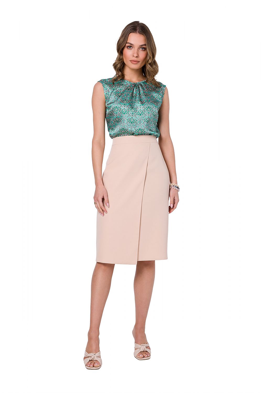 Front view of the Stylove green printed sleeveless blouse paired with an elegant beige skirt, epitomizing chic office style.