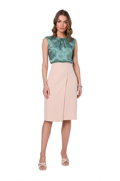 Front view of the Stylove green printed sleeveless blouse paired with an elegant beige skirt, epitomizing chic office style.