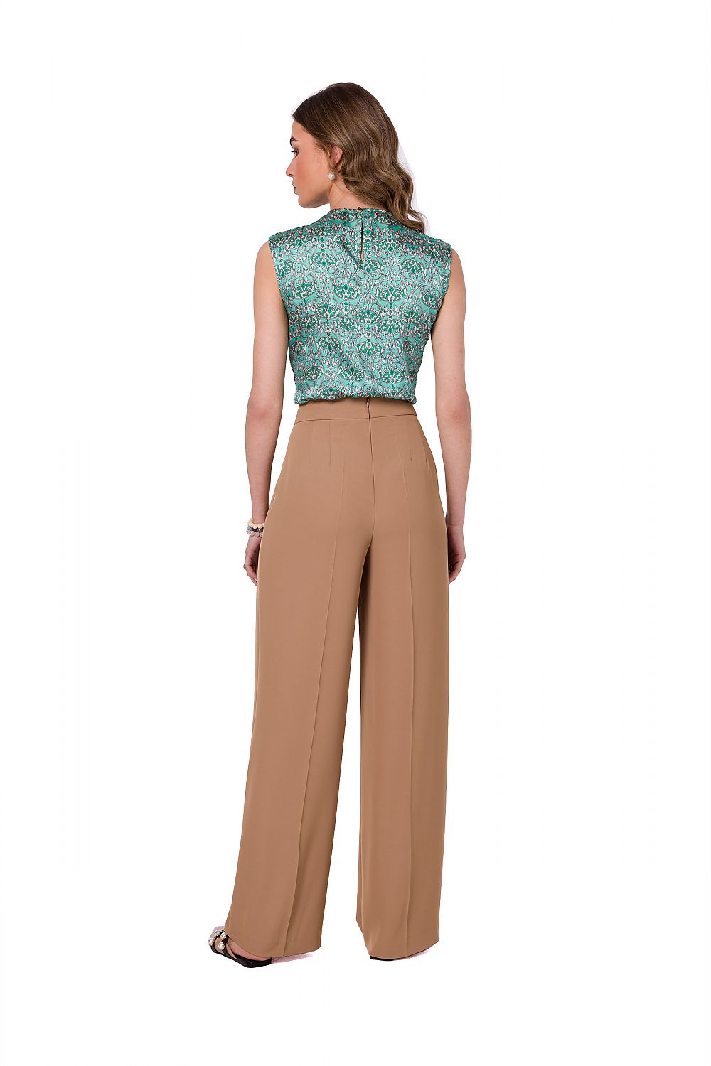 Back view of a model in elegant beige wide leg trousers by Stylove, demonstrating a fashion-forward and chic silhouette for women's attire.