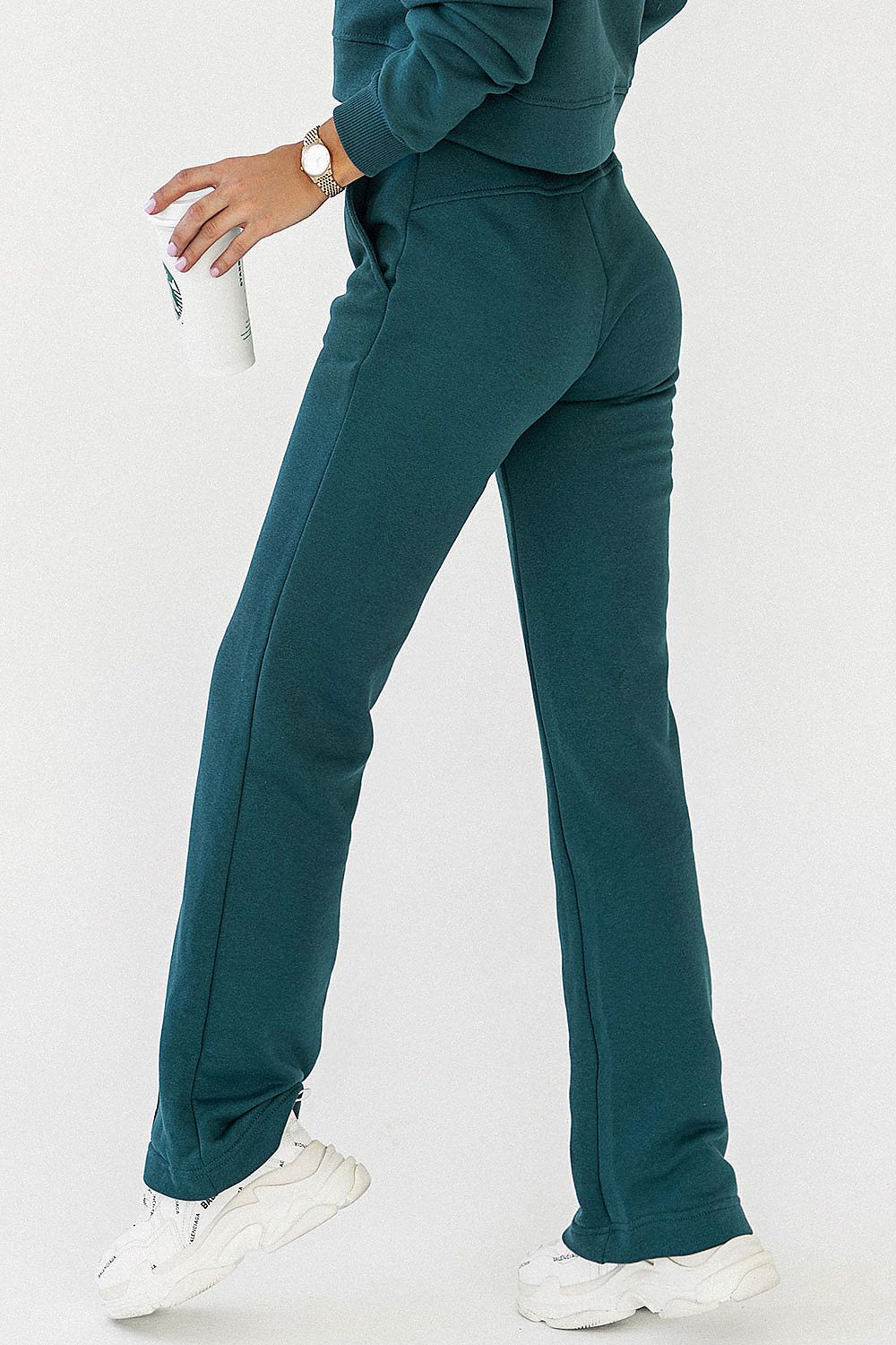 Close-up of IVON cotton blend sweatpants designed for comfort and style, featuring tasteful stitching and elastic waistband, paired with a minimalistic top.