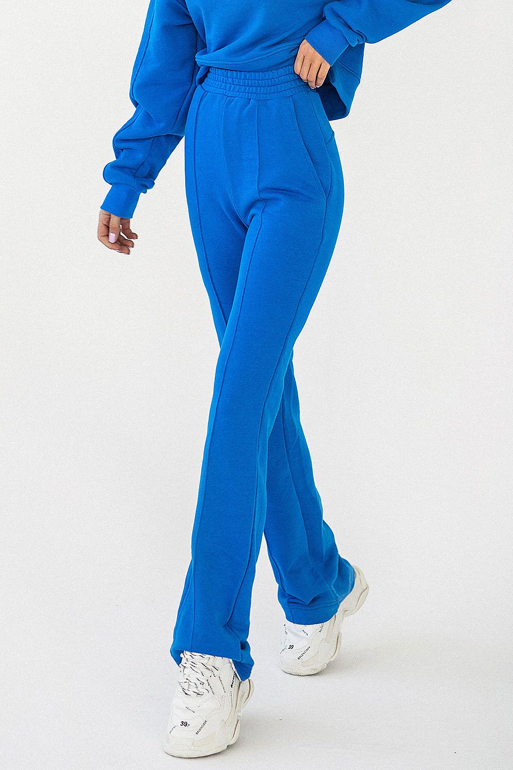 Dynamic angle of IVON cotton blend sweatpants in vibrant blue, showcasing a stylish relaxed fit perfect for comfort and luxury leisurewear.