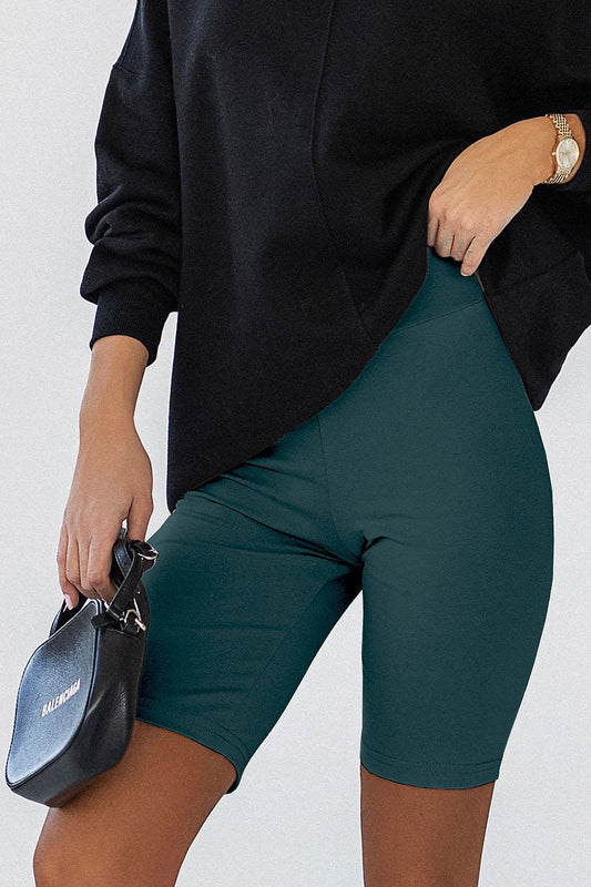 IVON Women's Classic Cycling Shorts in deep teal, featuring a soft cotton blend and elastic spandex for a perfect fit, styled with a chic black oversized sweatshirt.