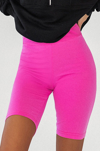 Vibrant pink IVON Women's Classic Cycling Shorts designed for comfort and style, showcased with a black oversized sweatshirt for a trendy look.