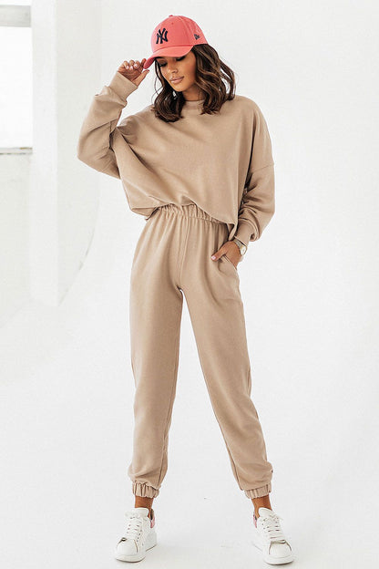 Stylish beige cotton blend joggers by IVON, showcasing a relaxed fit with an elastic waistband and pockets, perfect for a sophisticated athleisure look.