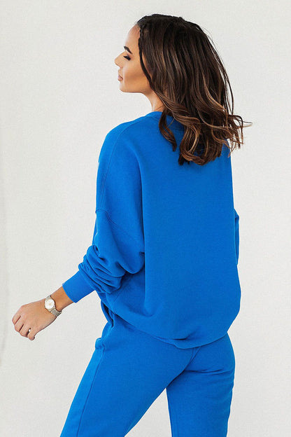 Sophisticated look of a woman in a blue IVON Oversized Sweatshirt, exuding stylish casual elegance and comfort from the back view.