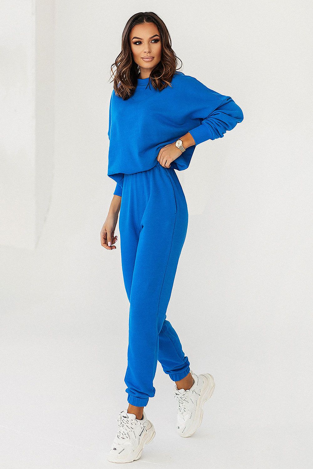 Chic female model flaunting the blue IVON Oversized Sweatshirt and joggers, showcasing contemporary fashion with a touch of luxury.