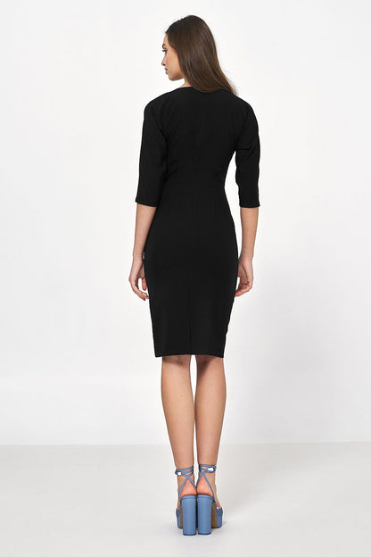 Rear view of an elegant black dress designed by Nife, featuring asymmetrical draping and 3/4 sleeves, perfect for sophisticated office and evening wear.