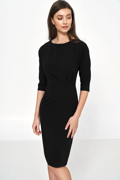 Front view of a stylish black dress by Nife, showcasing a boat neckline and flattering silhouette, ideal for luxurious everyday elegance.