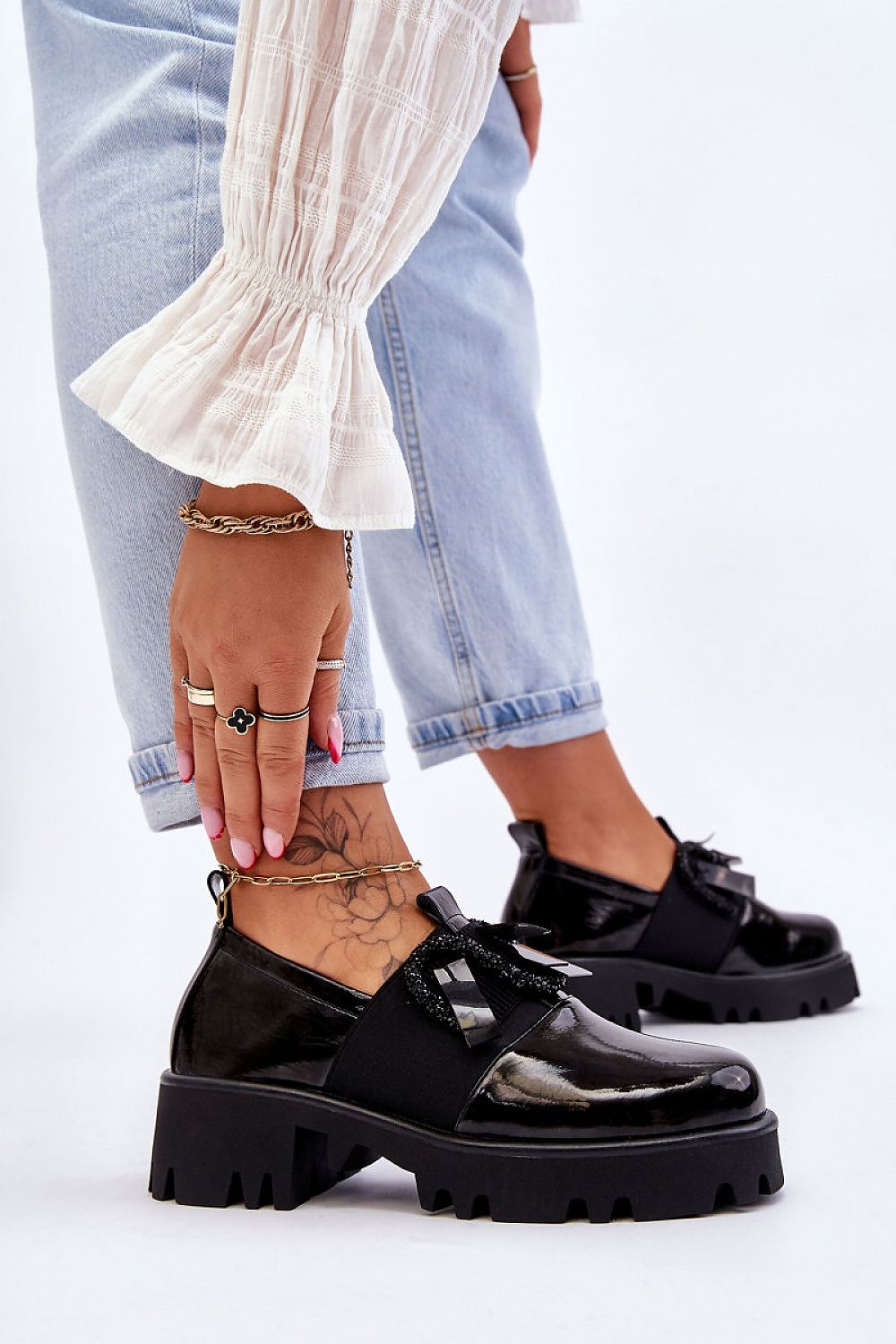 Elegant black slip-on heeled half shoes from Step in Style, featuring a 5cm chunky heel and decorative details, worn with stylish denim and accessories, embodying luxury and comfort.