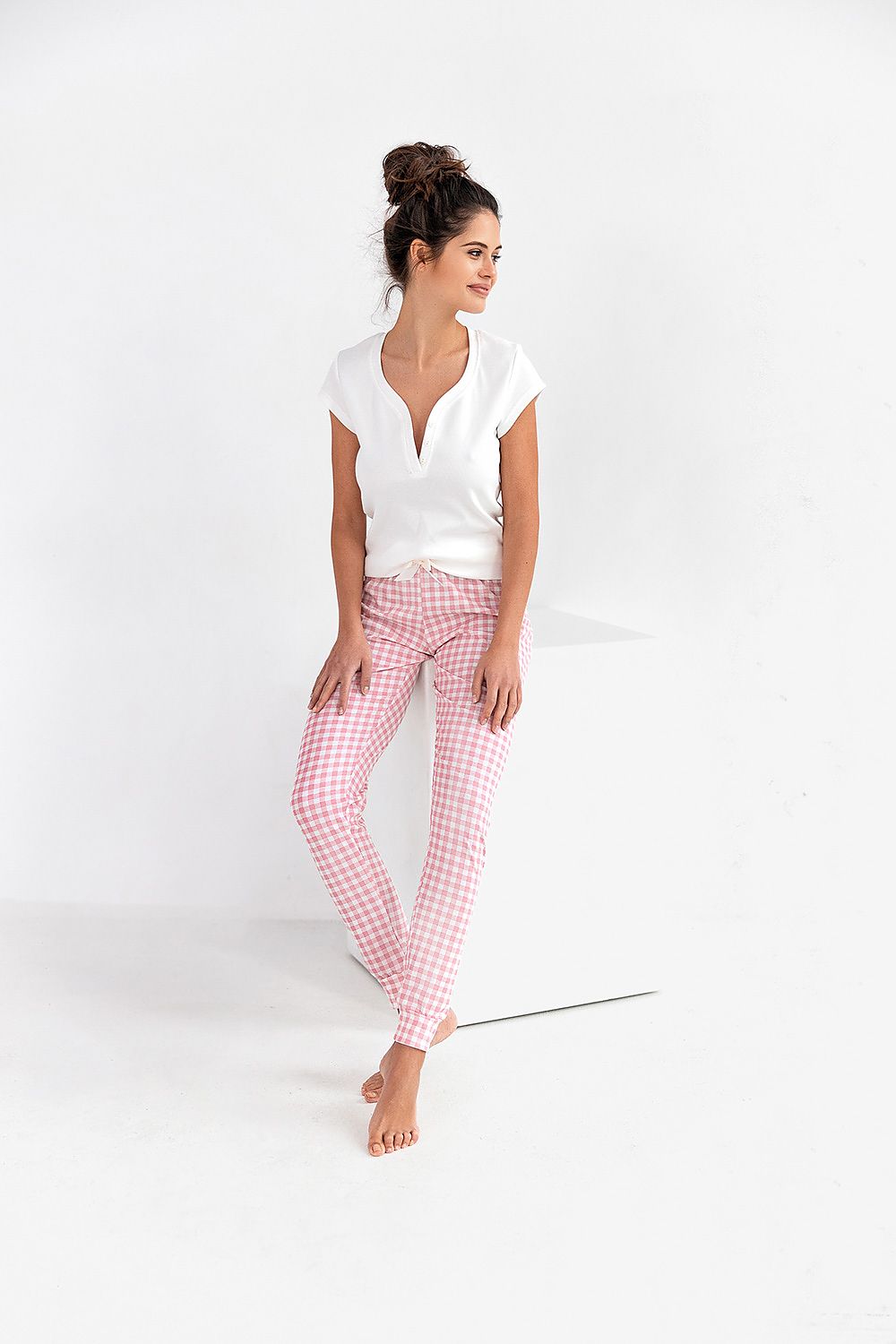 Elegant woman's cotton pajama set by Sensis, featuring a short sleeve white t-shirt and stylish pink checked long pants, perfect for a luxurious night in.