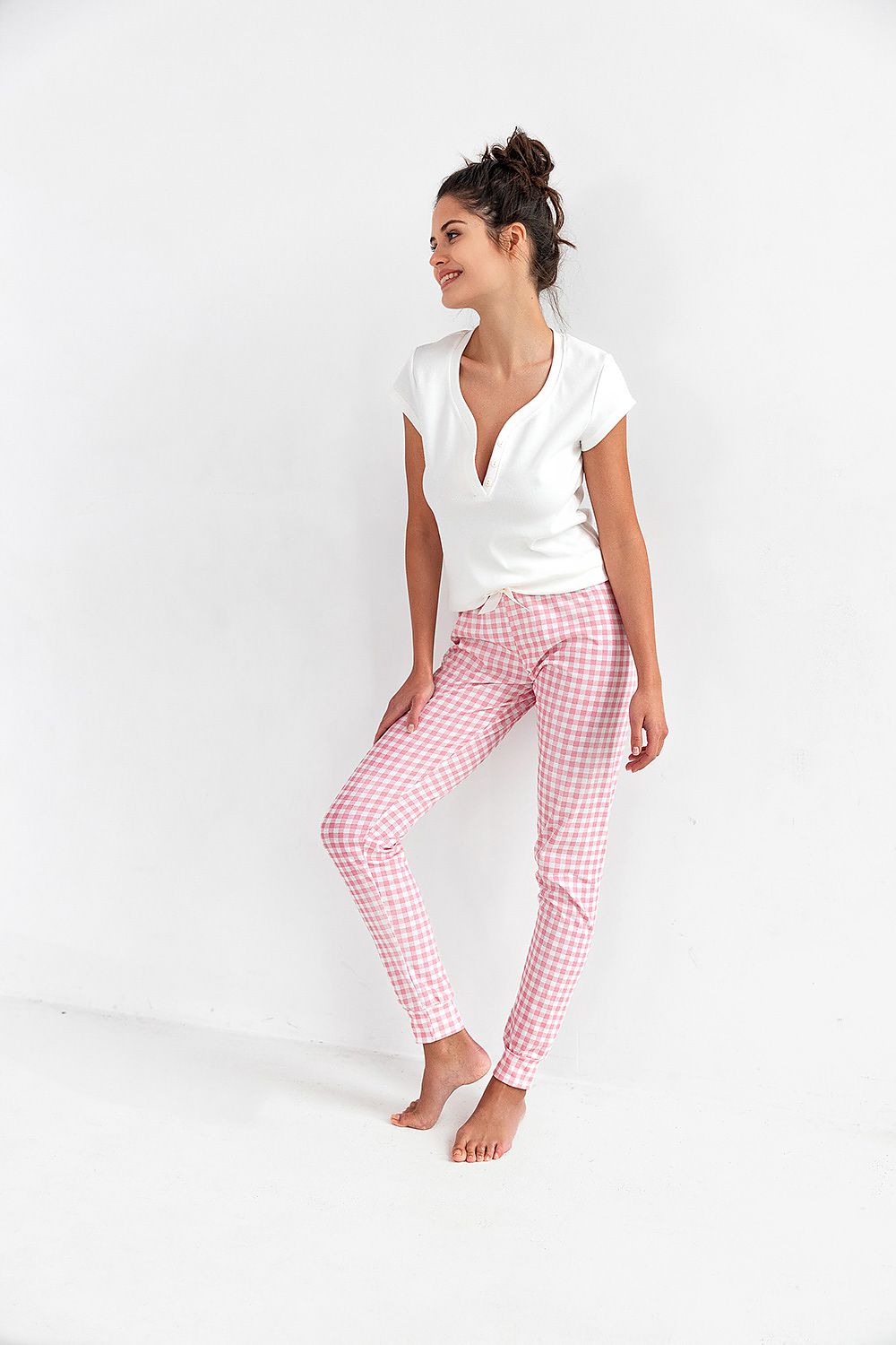 Chic woman's cotton pajamas by Sensis, showcasing a short sleeve white top paired with fashionable pink gingham long pants, ideal for comfort and style.