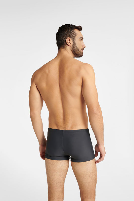 A male model displaying the back view of Henderson Men's GULF Swim Trunks, illustrating the elegant fit and premium material, perfect for water activities and refined leisure.