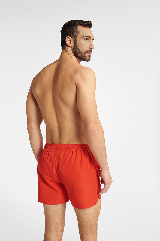 Henderson Men's quick-drying swim trunks in classic red, highlighting the rear view with adjustable waistband detail, model presenting a stylish and sporty look on a light background.