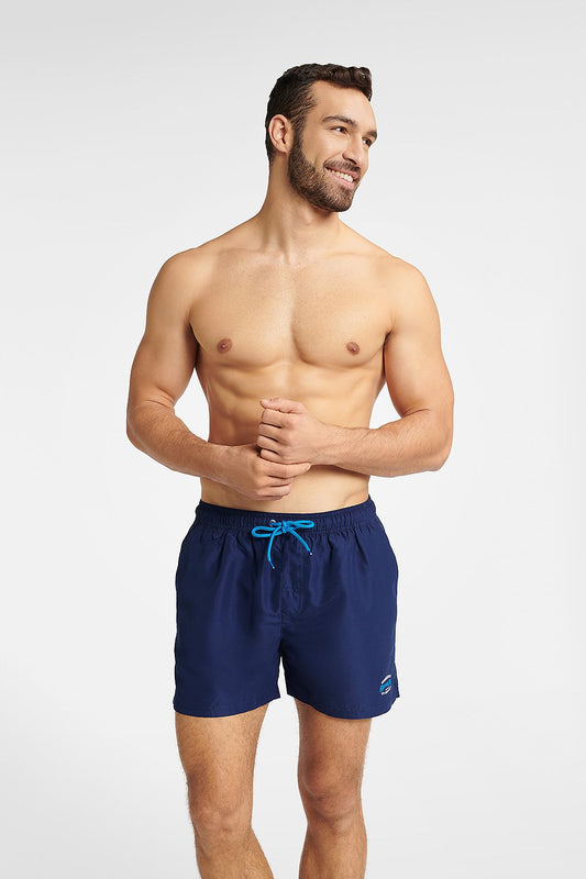 Stylish Henderson GUARD navy blue swimming trunks for men, showcasing a minimalist design with an adjustable fit, perfect for beach relaxation and water activities.