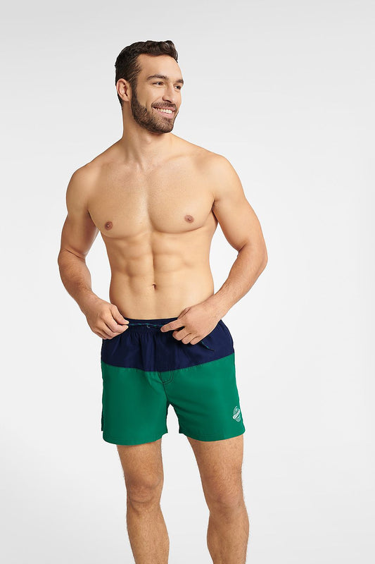 Stylish Henderson Men's GEM swim trunks in navy blue and green, showcasing a comfortable fit, mid-thigh length, and a relaxed design, perfect for summer activities.