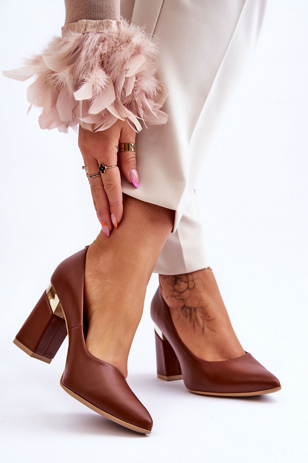 Sophisticated brown leather block heel pumps by Lewski Shoes, featuring a unique heel detail, styled for a fashionable and luxurious appearance.
