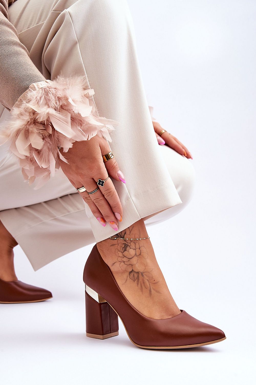 Elegant 9cm block heel pumps in natural leather with unique heel detail by Lewski Shoes, showcased in a stylish setting with a fashionable outfit.