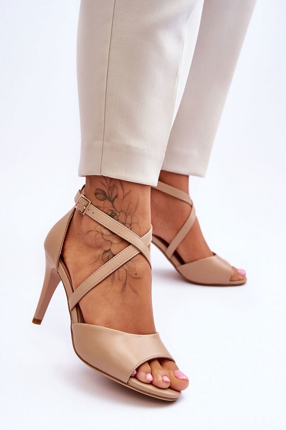Elegant 9cm high heel sandals with open round toe design, featuring an adjustable ankle strap, showcased by Step in Style. The image captures the luxurious appeal of the sandals paired with tailored trousers.