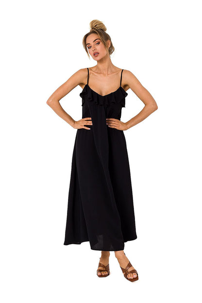 Moe's elegant midi dress in classic black with ruffled detailing at the neckline, model posing for a chic and casual style.