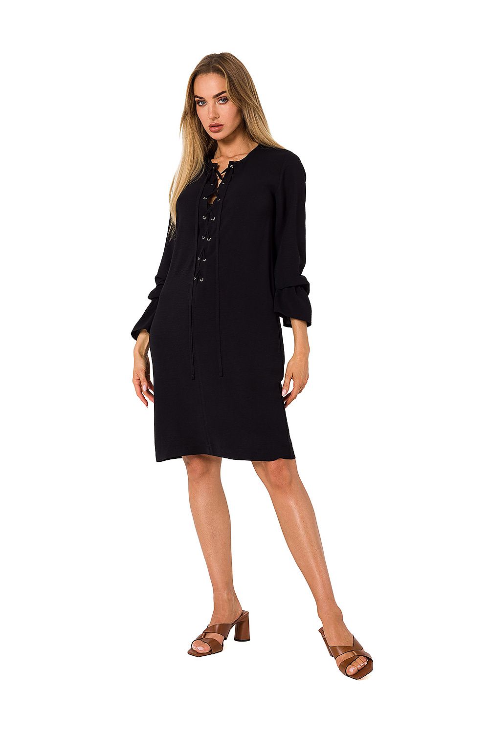 Sophisticated model showcasing a black long sleeve dress by Moe with a modern lace-up front design, perfect for timeless style.
