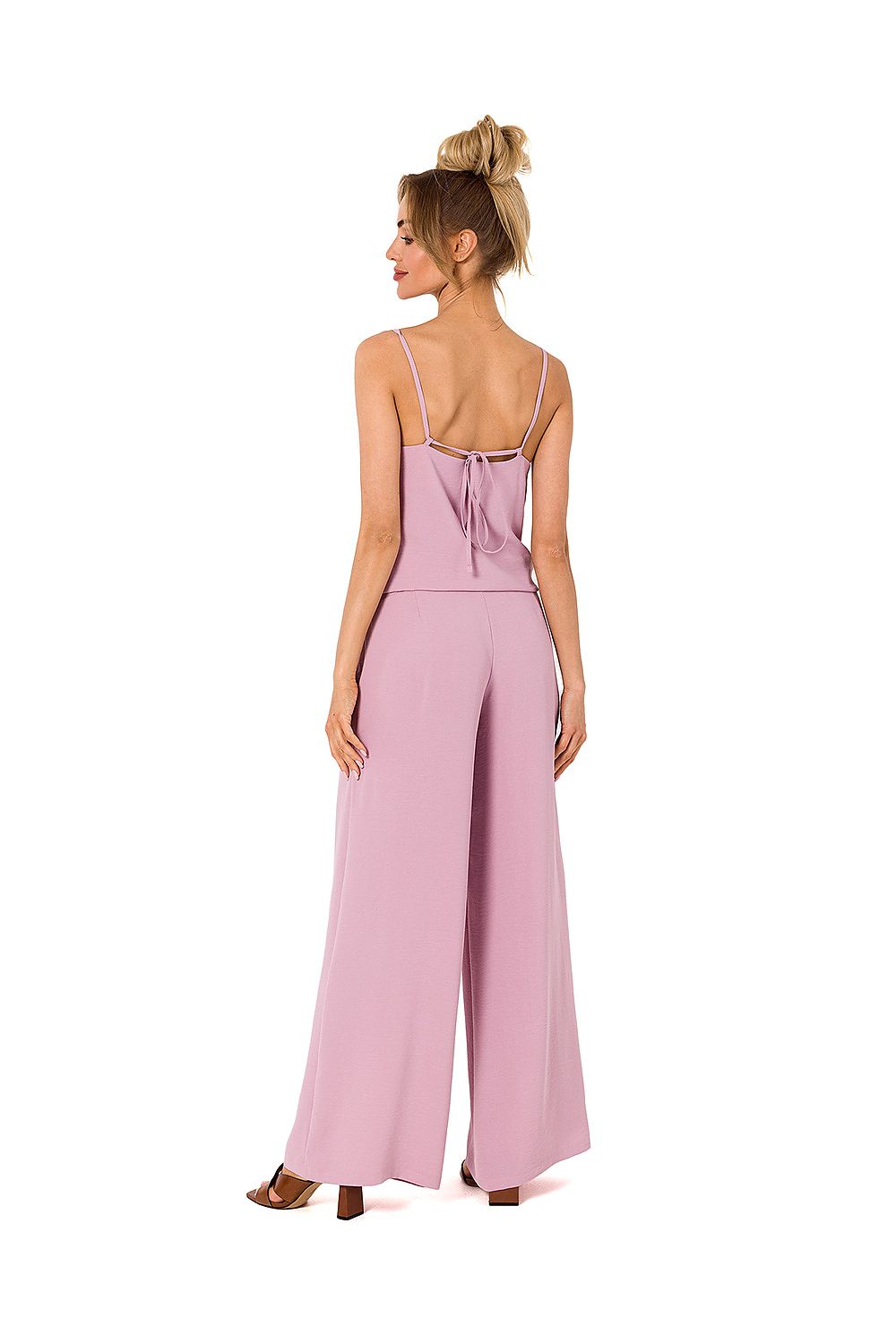 Stylish pastel pink pantsuit with a draped neckline and tie-back straps, designed by Moe, ideal for elegant events.