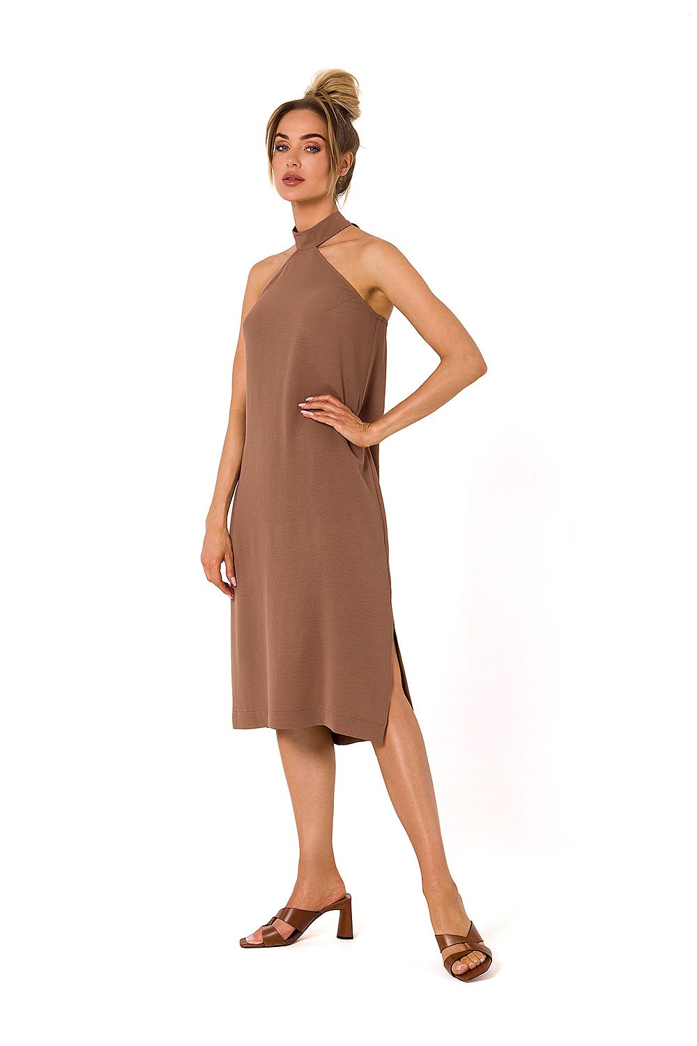 A model showcases an elegant halter neck crepe daydress with an open back in a warm brown tone, perfect for both day and evening occasions, by Moe.