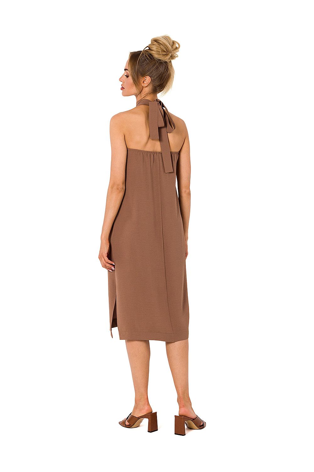 Rear view of a model wearing an elegant halter neck crepe daydress with an open back in brown, featuring a stylish tie detail, designed by Moe.
