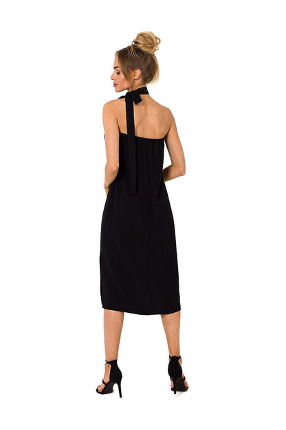 Back view of a refined black halter neck crepe daydress with an open back and bow detail, epitomizing sophistication for any occasion, designed by Moe.