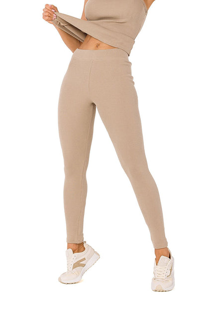 Sophisticated beige ribbed knit leggings by Moe, complemented with a matching cropped tank top, offering a luxurious yet casual aesthetic.