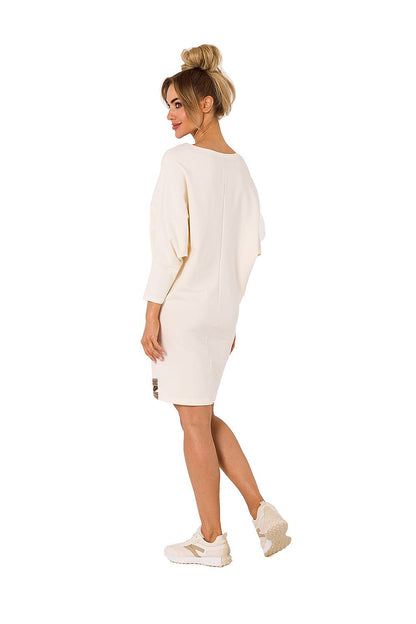 Elegant cream daydress from Moe featuring kimono sleeves and V neckline, complemented by logo piping, exuding a luxurious aesthetic.