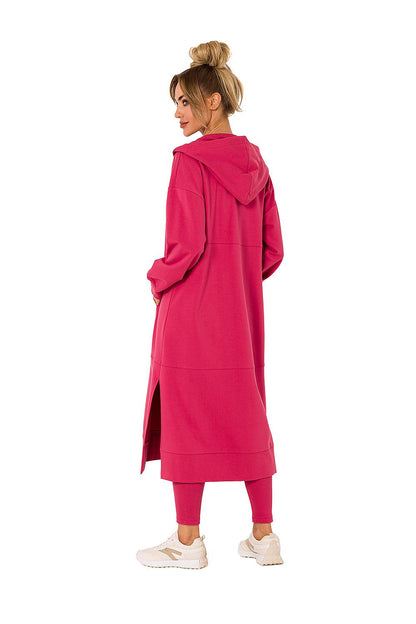 Stylish pink hooded sweatshirt by Moe, highlighting a model from the back, perfect for layering with its comfortable, long design and functional pockets.