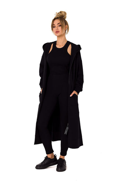 Chic black hooded sweatshirt by Moe, spotlighting a model in a front pose, designed for both warmth and sophistication with an elegant long fit.