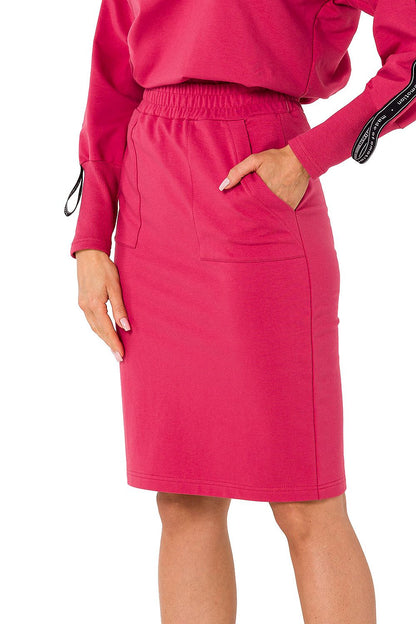 Close-up of Moe women's knit sweatshirt skirt in a rich pink hue, highlighting the practical pockets and elastic waistband.