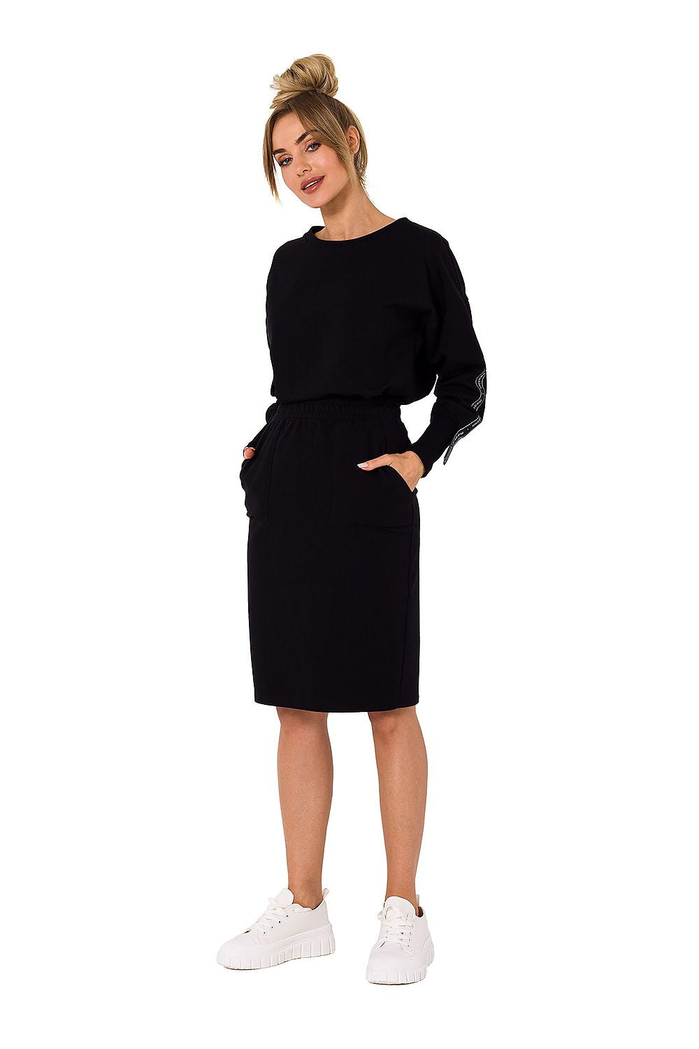 Elegant Moe Women's black knit sweatshirt skirt styled with a relaxed fit and front pockets, perfect for a chic casual look.