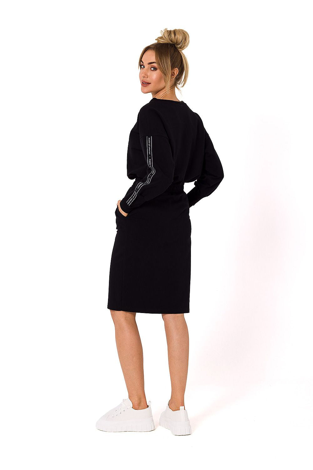 Sophisticated Moe Women's black knit sweatshirt skirt showcased from the back, highlighting its flattering cut and comfortable design.