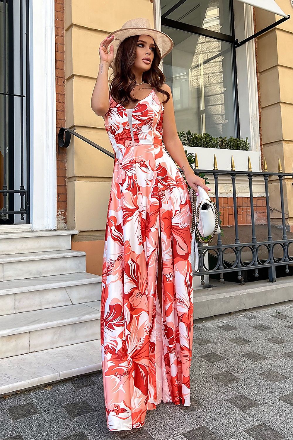 Chic look featuring an elegant floral satin long dress by Bicotone, model facing the camera with a confident pose, complemented by a stylish hat and handbag.