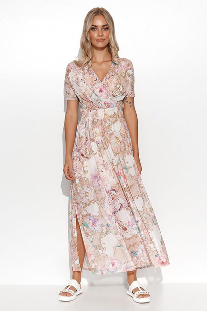 Elegantly styled Makadamia mini dress featuring a sensual neckline and captivating floral and abstract motifs. The model showcases the intricate design, perfect for summer occasions.