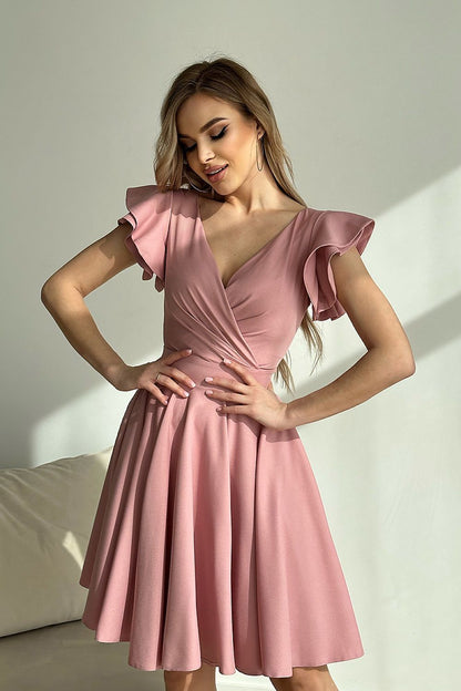 Elegant Bicotone cocktail dress in soft pink, featuring ruffled sleeves and a tailored fit, perfect for sophisticated charm and girlish allure.