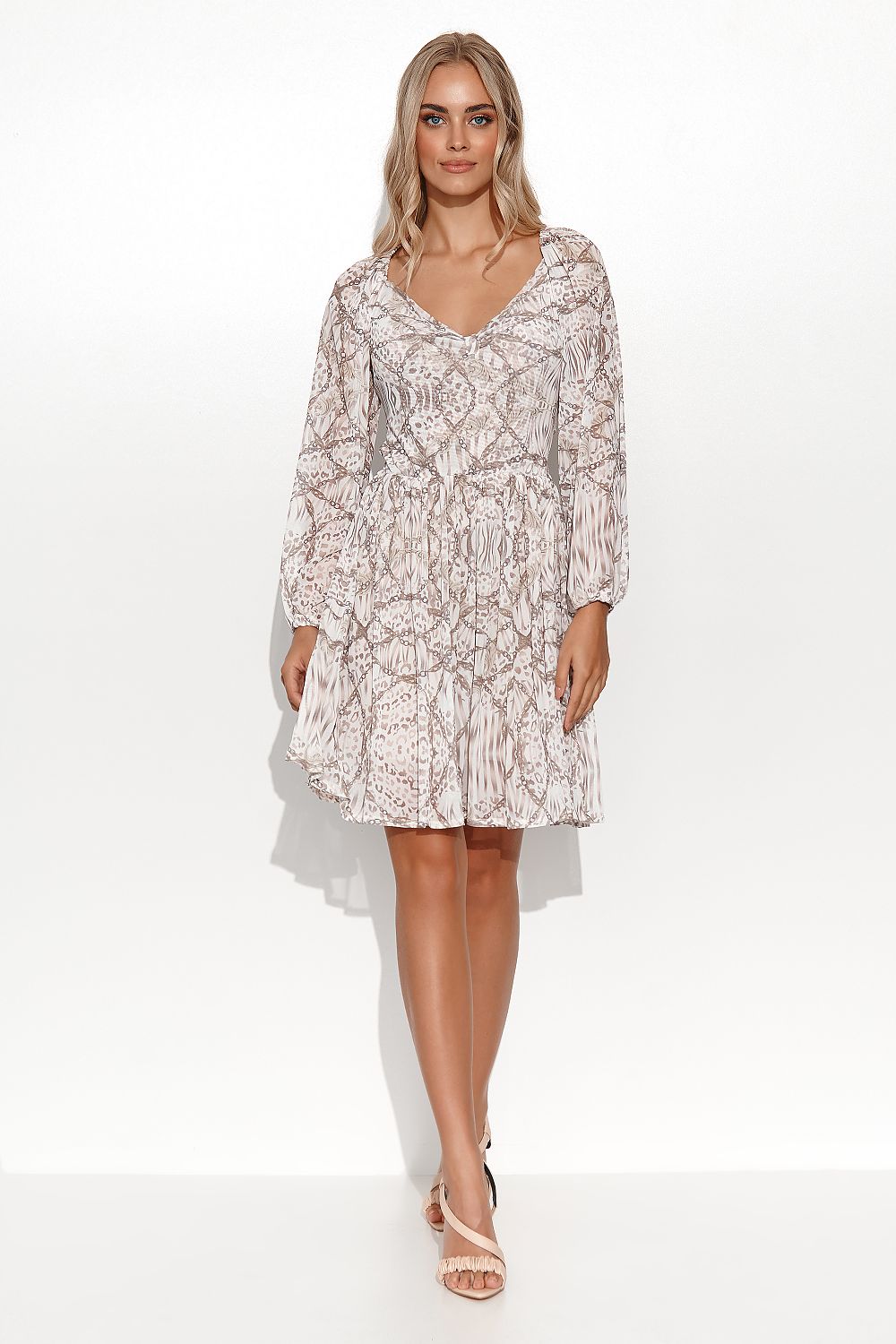 Chic Makadamia Airy Daydress in a delightful pattern, designed with long sleeves and a flattering silhouette. Model posing elegantly to highlight the dress's girly features.