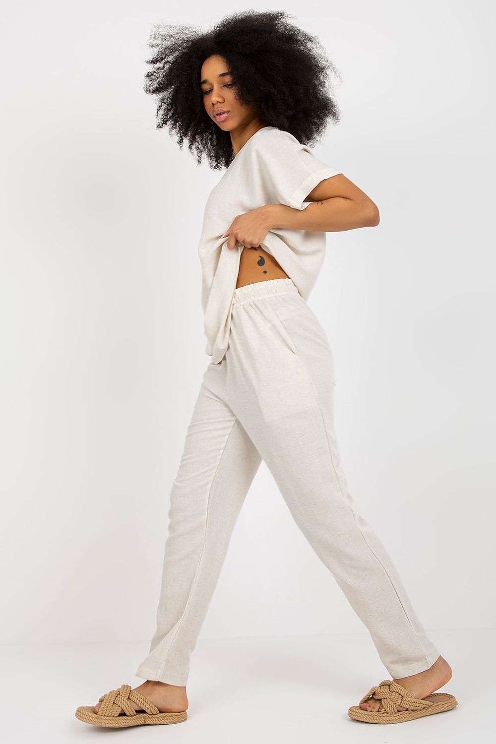 Dynamic pose of a model wearing the Rue Paris summer set, demonstrating the versatility of the cotton-linen blend fabric and the chic design elements for summer elegance.