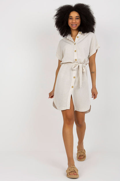Elegant short-sleeved button-down summer dress by Rue Paris, showcasing a relaxed fit with a waist tie, perfect for a chic summer outing.
