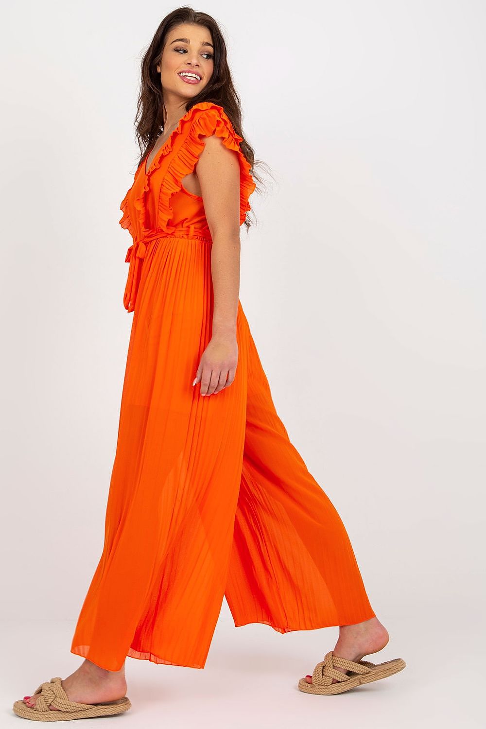Elegant Och Bella pleated wide leg jumpsuit in striking orange, featuring a stylish v-neckline and ruffled sleeves, perfect for upscale occasions.