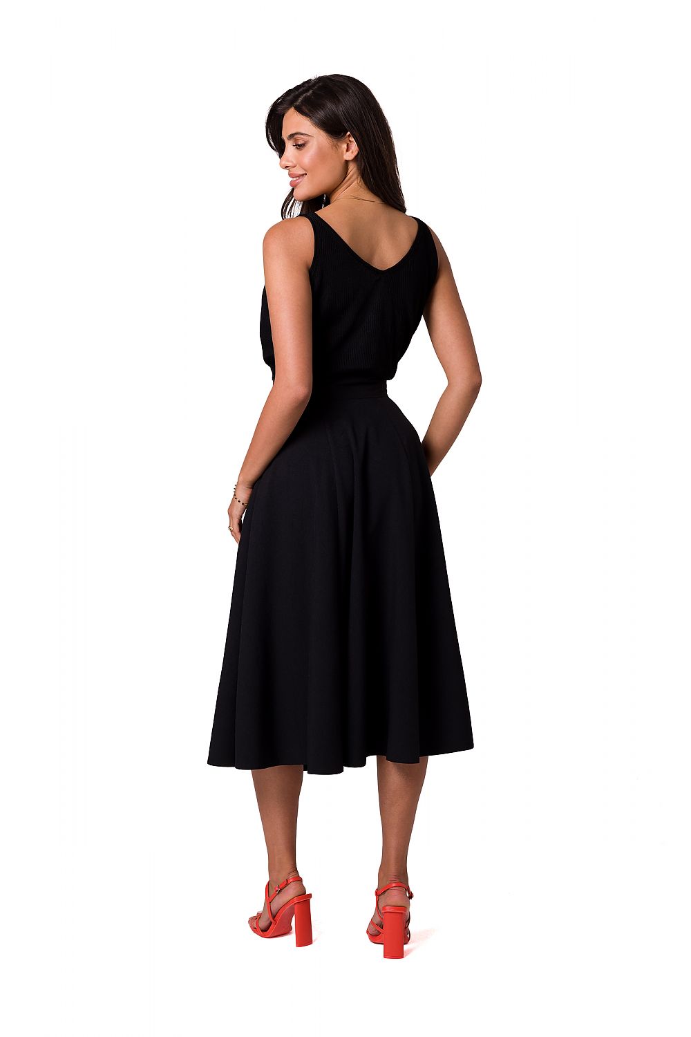 Back view of a luxurious flared midi skirt from BeWear, featuring decorative buttons, paired with a black top, highlighting an elegant silhouette.