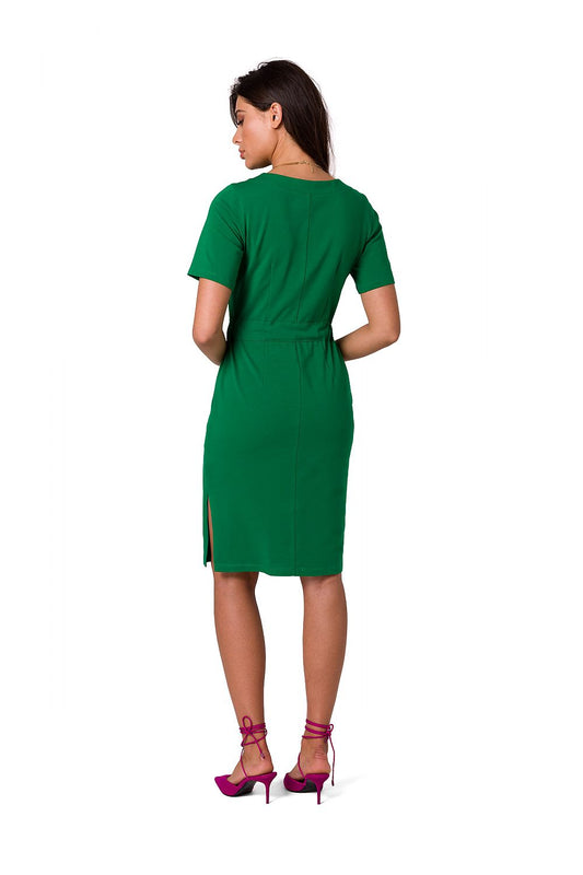 Back view of an elegant green fitted cotton knit dress with belt and side slits by BeWear, elegantly designed for comfort and style.